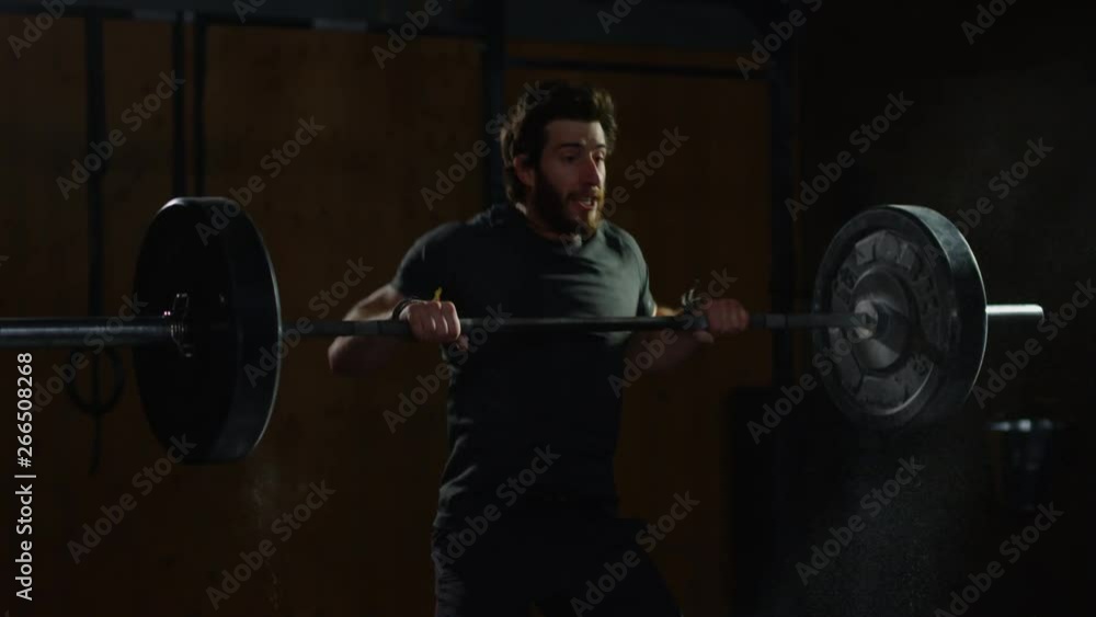 Young guy in crossfit gym working out Young guy in crossfit gym working out