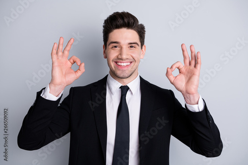 Close up photo amazing he him his macho handsome hands arms fingers okey symbol advising new tested product quality wear white shirt black suit jacket tie formal-wear isolated bright grey background