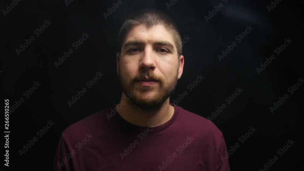 Man exhales vapor into the camera. Man exhales vapor into the camera.