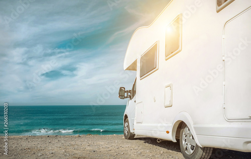 White travel caravan car stay on the beautifull ocean coastline