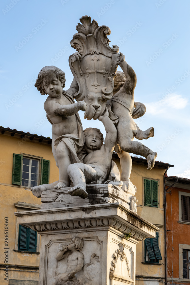 PISA, TUSCANY/ITALY  - APRIL 18 : Statue of cherubs in front of the Leaning Tower of Pisa Tuscany Italy on April 18, 2019