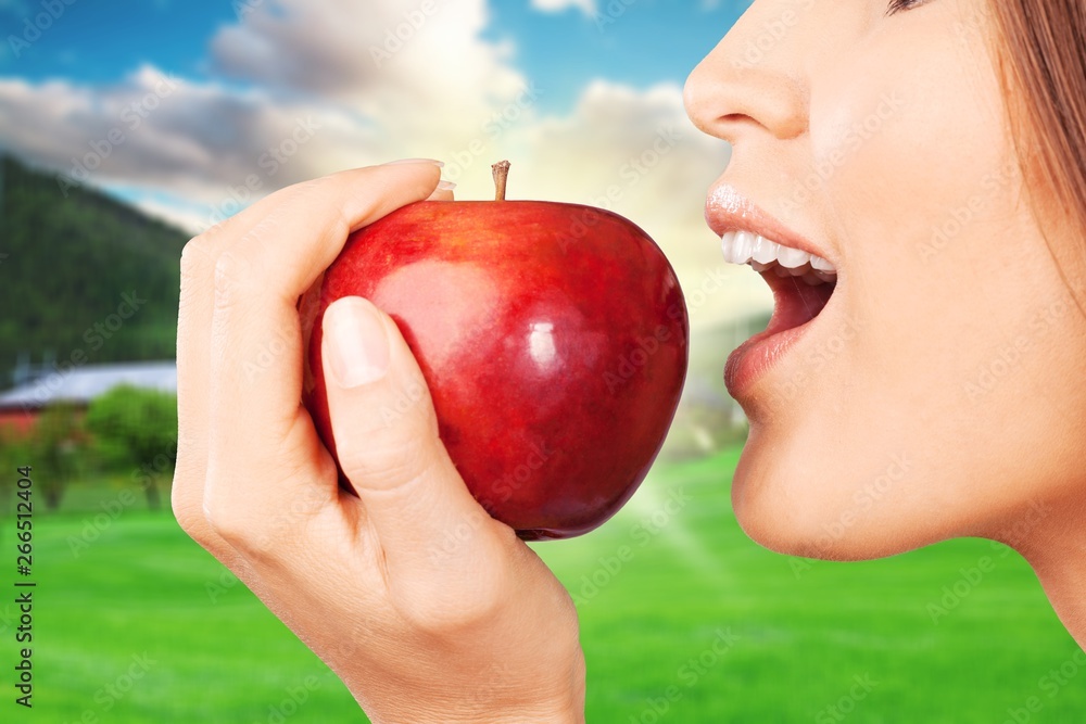 Young woman holding fresh apple on white background Young woman holding fresh apple on white background