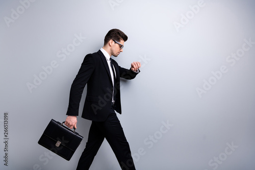 Profile side view portrait of his he nice classy chic attractive guy carrying diplomat marketing manager looking at minute late to office white collar shirt necktie isolated over light gray background photo