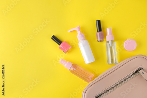 Stylish fashionable pink bag and women's cosmetics and accessories on a bright trendy yellow background. female accessory concept. top view