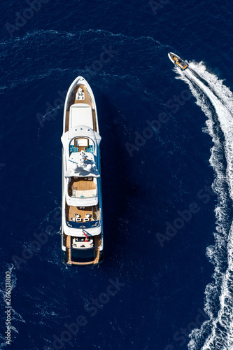 Top view luxury yacht and small motorboat in the sea  © LaptevArt