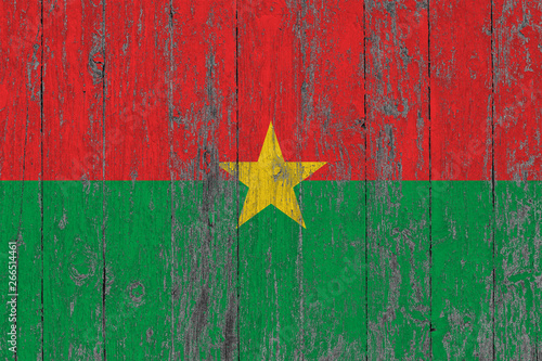 Flag of Burkina Faso painted on worn out wooden texture background.