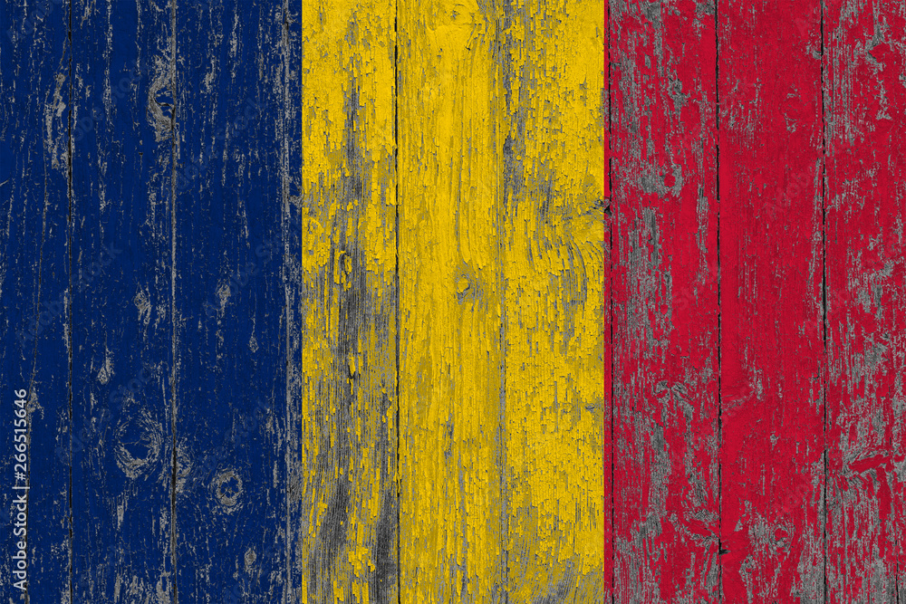 Flag of Chad painted on worn out wooden texture background.