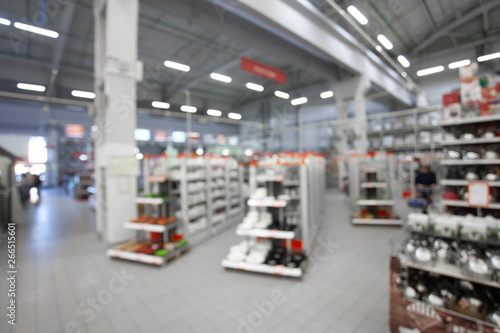 Blurred concept of DIY shopping center. Shelving with household products and kitchenware. Commercial LED lighting. Merchandising in retail. © Anton Gepolov