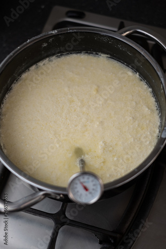 Milk being heated in a pan to make cheese