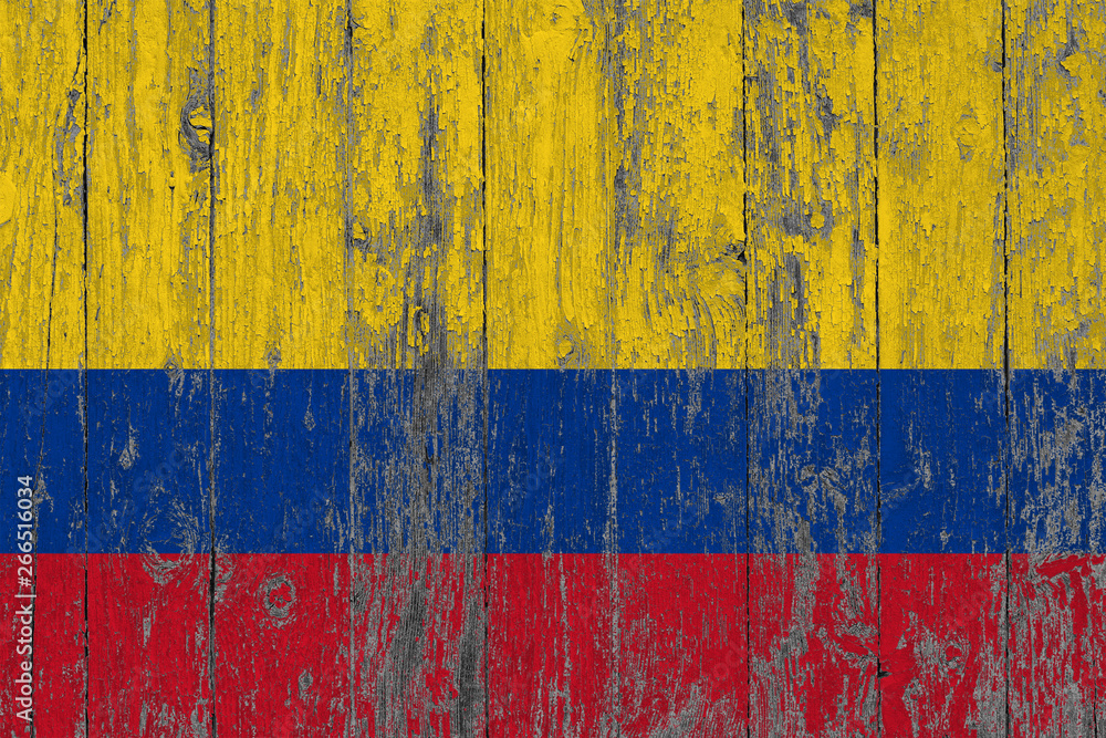 Flag of Colombia painted on worn out wooden texture background.