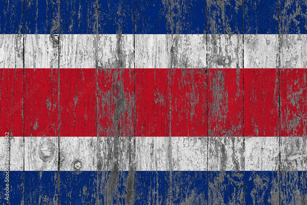 Flag of Costa Rica painted on worn out wooden texture background.
