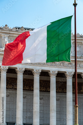 Italian flag fluttering in front of the Fatherland from Piazza Venezia in Rome, Italy, also known as National Monument to Victor Emmanuel II