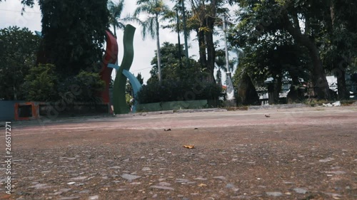 basketball player takes the ball from the ground with one hand low angle photo