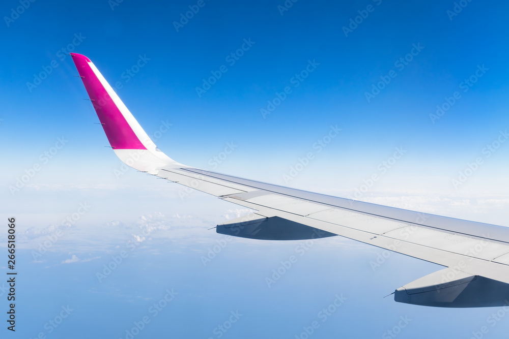 View from airplane window on blue sky and airplane wing. Travel concept. View from airplane window on blue sky and airplane wing. Travel concept.