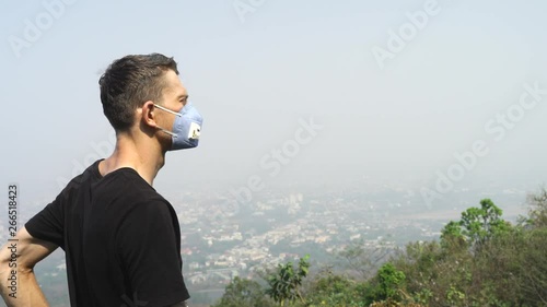 Chiang Mai young tattooed man wearing a face mask to prevent the toxic air inhalation. photo