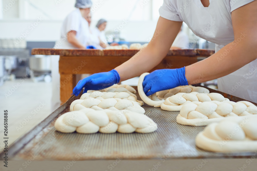 Raw baked dough lies on the table before baking at the bakery.