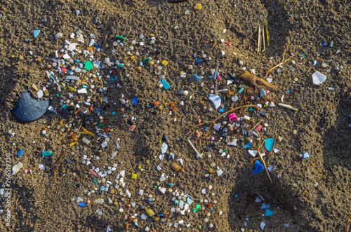 Micro plastics mixed in the sand of the beach photo