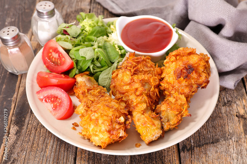 crispy chicken leg with salad and ketchup