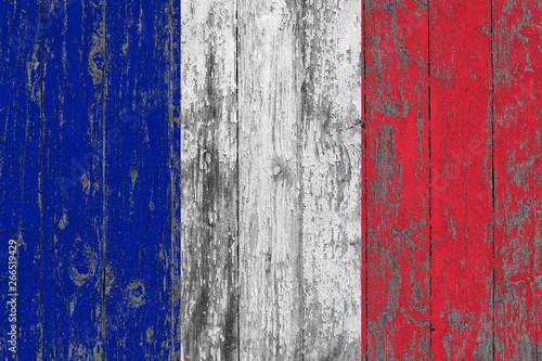 Flag of France painted on worn out wooden texture background.