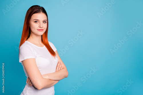 Portrait of her she nice attractive lovely winsome charming confident cheerful girl wearing white t-shirt folded arms copy space isolated over bright vivid shine blue background © deagreez