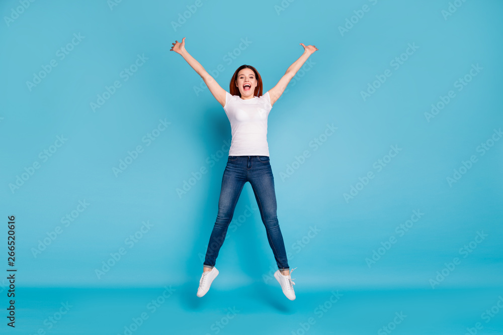Full length body size view portrait of her she nice attractive lovely cheerful cheery girlish girl wearing white tshirt having fun time isolated over bright vivid shine blue background