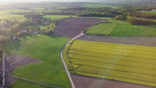 Aerial, impressive scene from high altitude of a rural road that passes through several fields