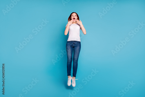 Full length body size view portrait of her she nice attractive cheerful cheery crazy girl wearing white tshirt having fun time isolated over bright vivid shine blue background