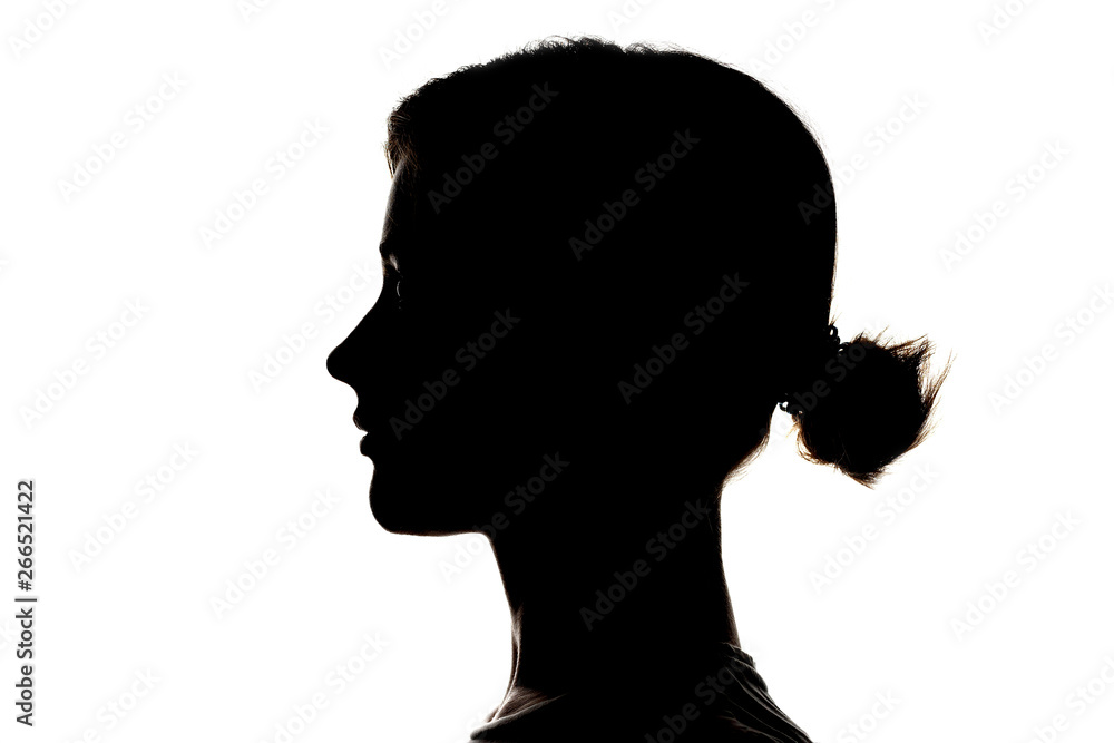 Dark silhouette profile of a young girl on white background, concept of anonymity