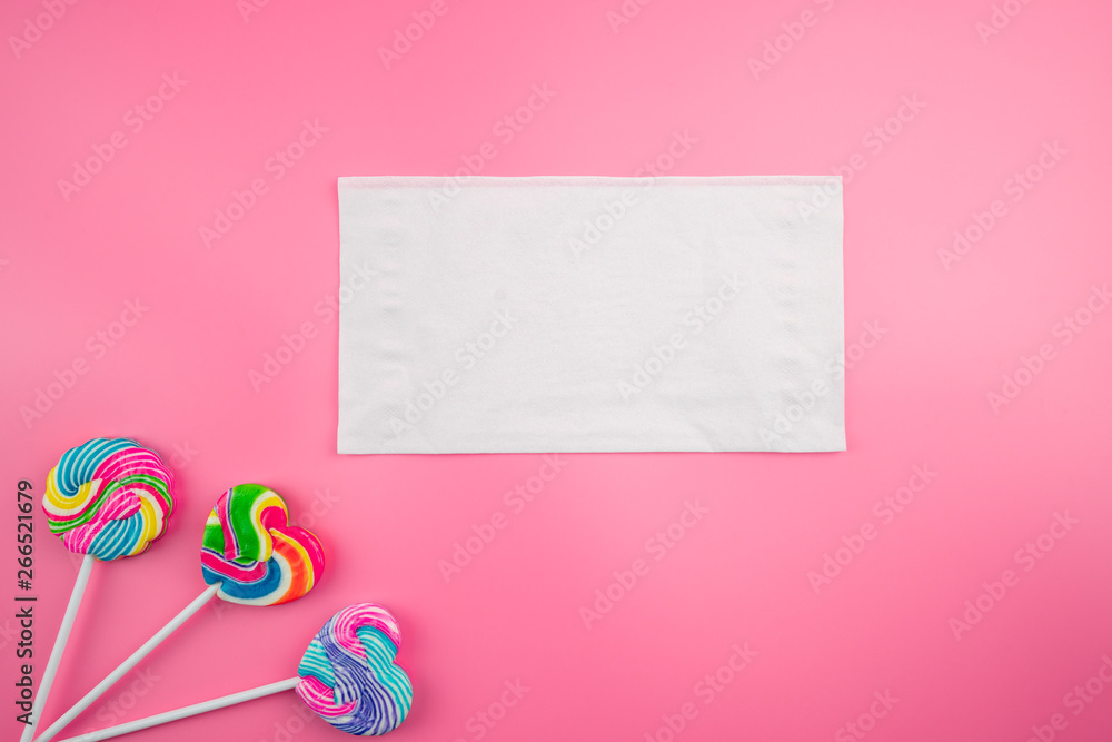 Multicolored lollipops on a pink background
