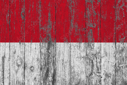 Flag of Indonesia painted on worn out wooden texture background.