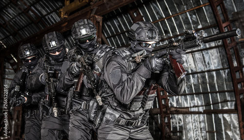 Police tactical group sneaking in industrial area