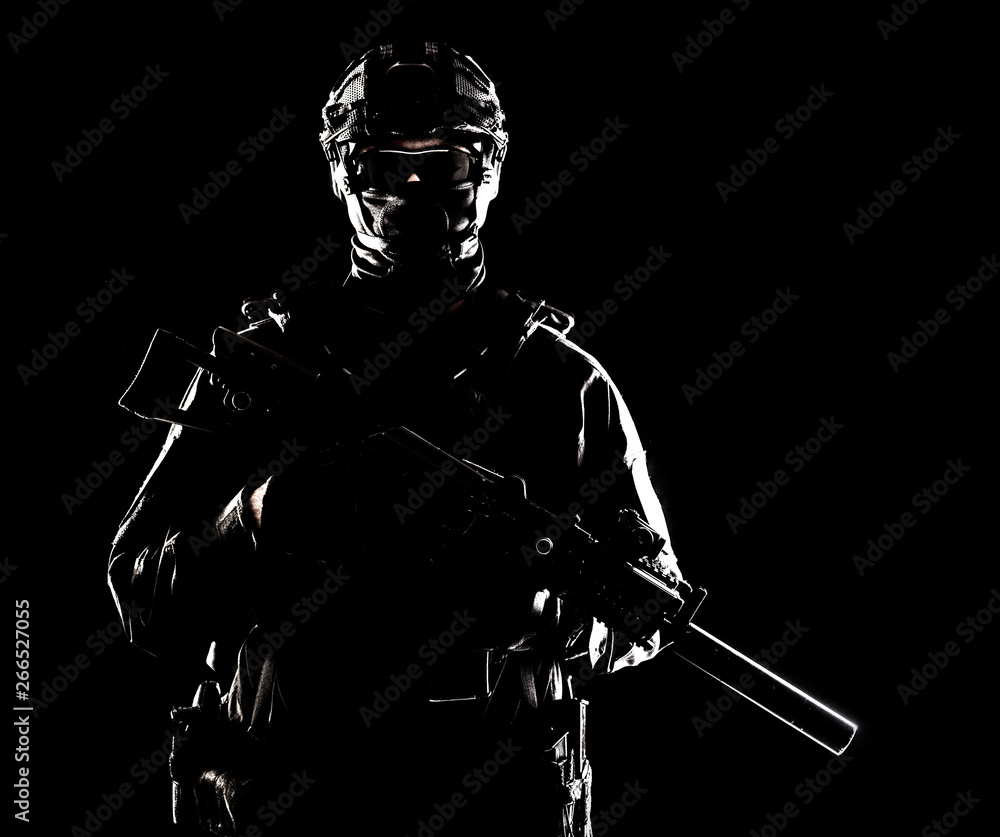 Naklejka premium SWAT officer with service rifle low key portrait