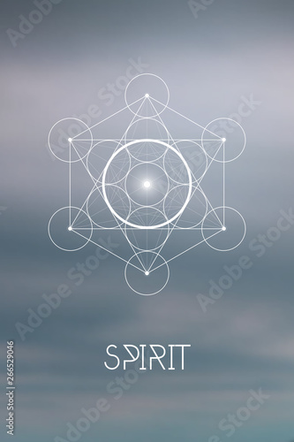 Sacred geometry Spirit or Aether element symbol inside Metatron Cube and Flower of Life in front of natural blurry background.