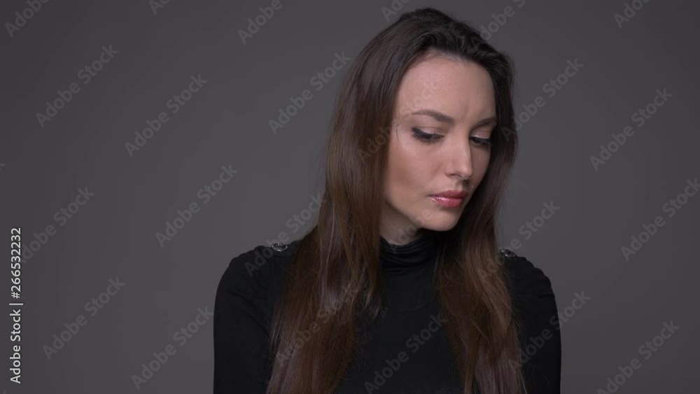Closeup portrait of adult attractive caucasian female waving her head saying no looking at camera with background isolated on gray Closeup portrait of adult attractive caucasian female waving her head saying no looking at camera with background isolated on gray