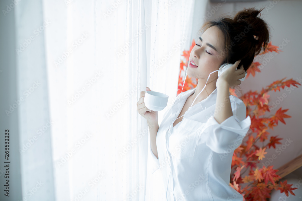 oung beautiful woman in bright outfit enjoying the music at home oung beautiful woman in bright outfit enjoying the music at home