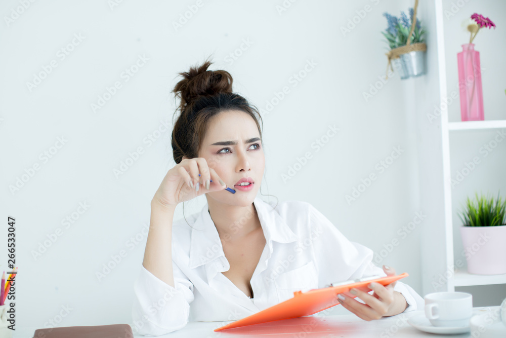 Beautiful young woman working on her laptop in her room. Beautiful young woman working on her laptop in her room.