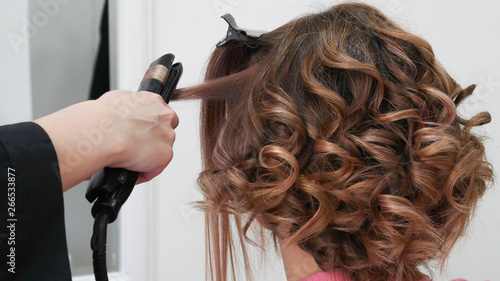 Female Hairstyles on curling in a beauty salon 