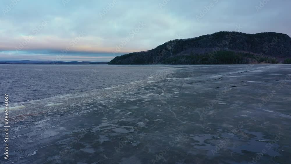 Weather- Aerial view of floe covered on the Moosehead lake surface. Cold freezing water. Frigid weather.