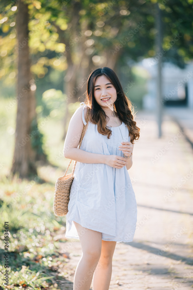 Portrait of Young Asian woman girl smile in flower garden