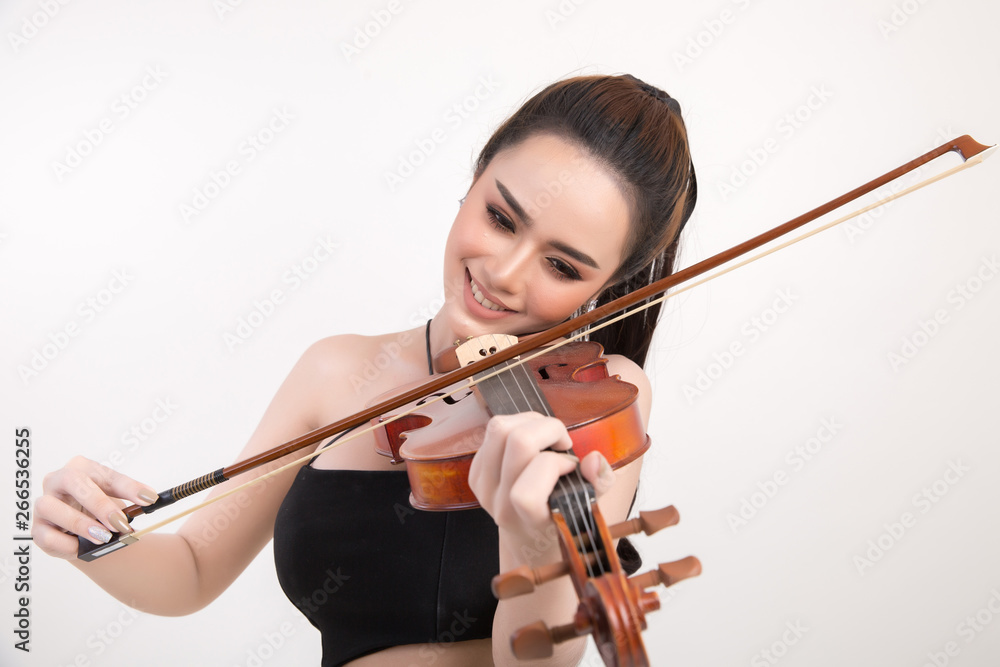 Beautiful young woman playing violin over white background Beautiful young woman playing violin over white background