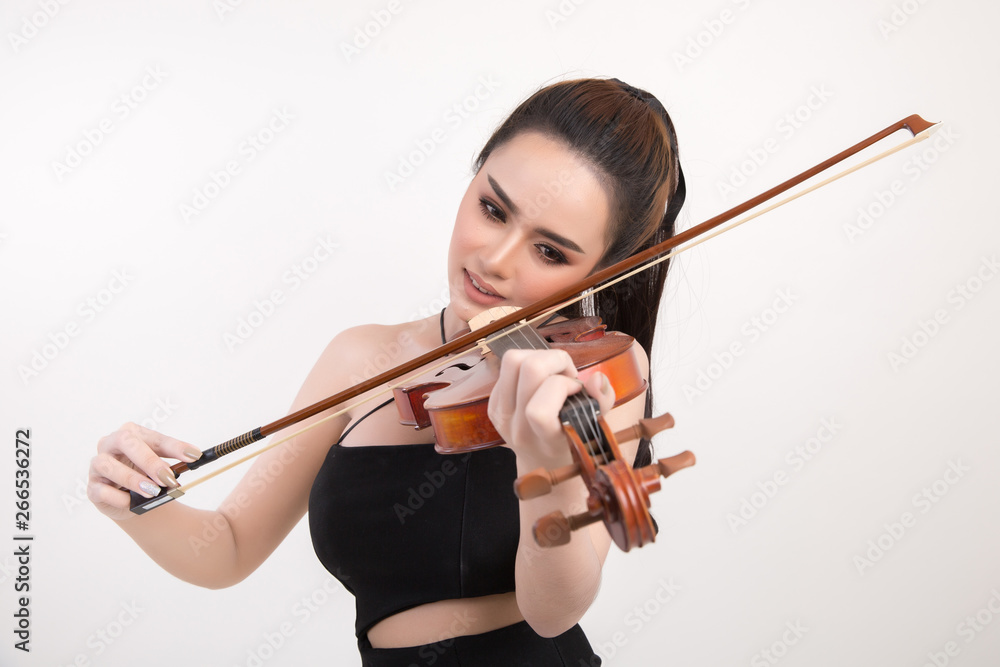 Beautiful young woman playing violin over white background Beautiful young woman playing violin over white background