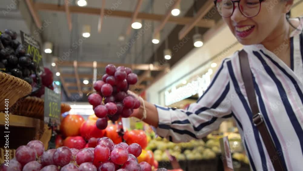 Happy woman buying fresh fruit in convenience store Happy woman buying fresh fruit in convenience store