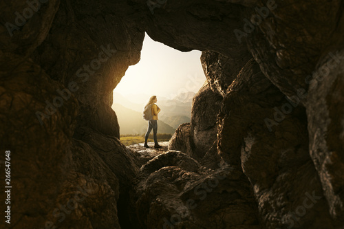 Wanderin steht an Höhlenausgang