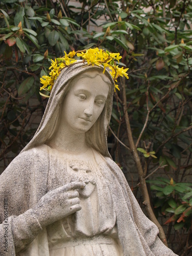 Crowning of Mary statue with spring flowers