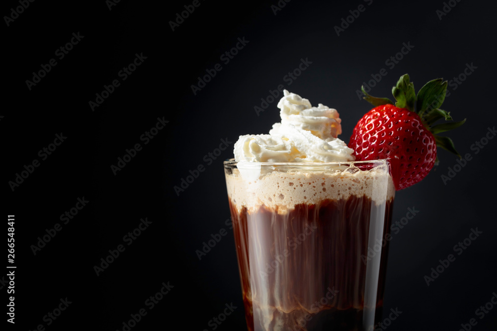 Chocolate drink with whipped cream and strawberry on a dark background. Chocolate drink with whipped cream and strawberry on a dark background.