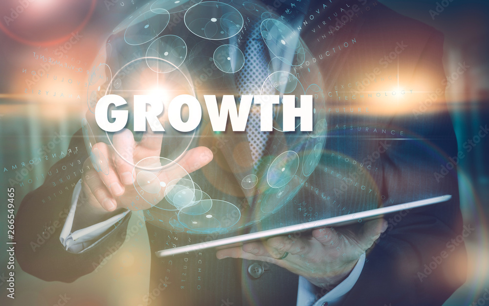 Fototapeta premium A hand selecting a Growth business concept on a futuristic computer display.