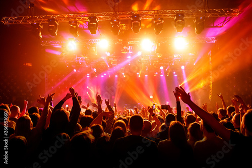 Raised hands in honor of a musical show on stage