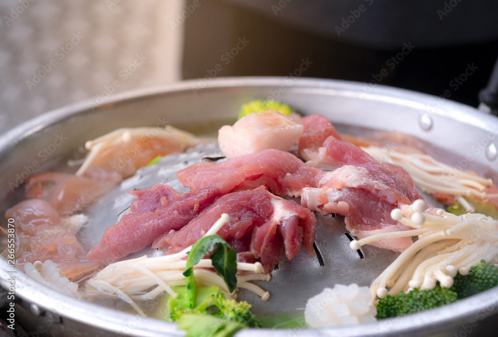 Close up view of Thai barbecue. Fresh meat on the grill and cooking pot put the ingredients into a variety. The menu is popular in Thailand. Close up view of Thai barbecue. Fresh meat on the grill and cooking pot put the ingredients into a variety. The menu is popular in Thailand.