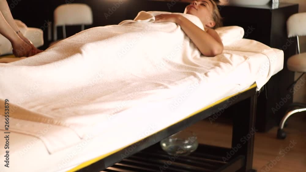 Young woman getting body massage with oil in resort spa salon. Young woman receiving hand massage in luxury spa center. Body relaxation and skin care. Young woman getting body massage with oil in resort spa salon. Young woman receiving hand massage in luxury spa center. Body relaxation and skin care.