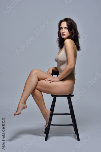 Beautiful woman in underwear sitting on the chair.